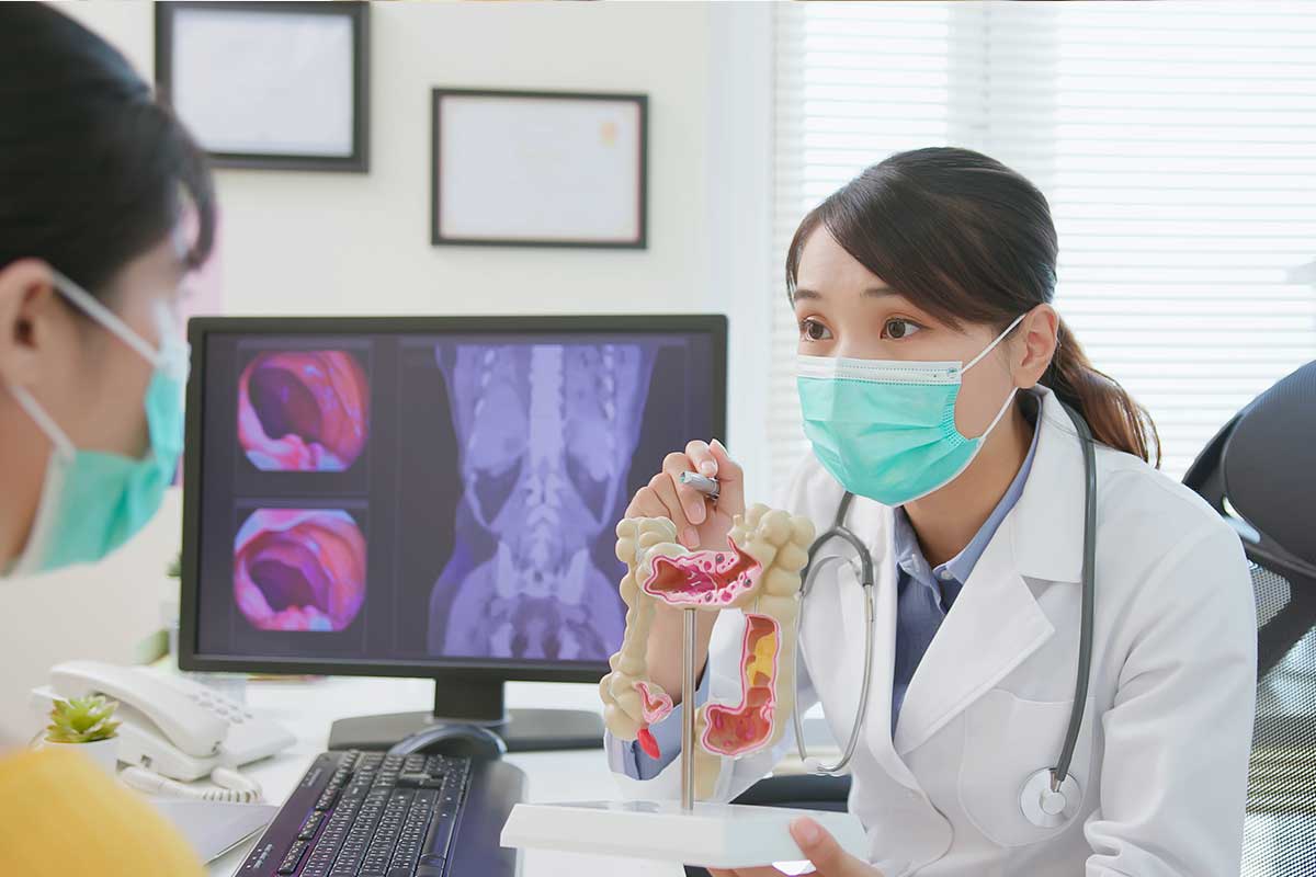 doctor with colon model talking to patient