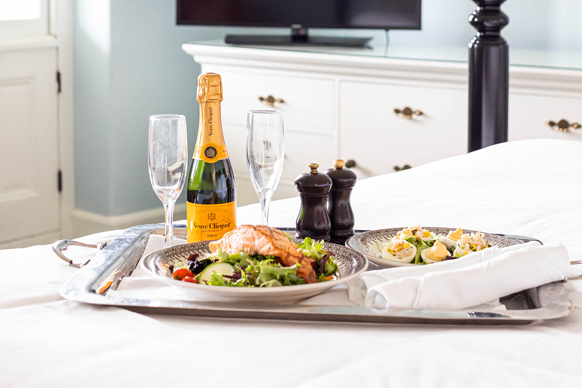 tray with champagne and food for two