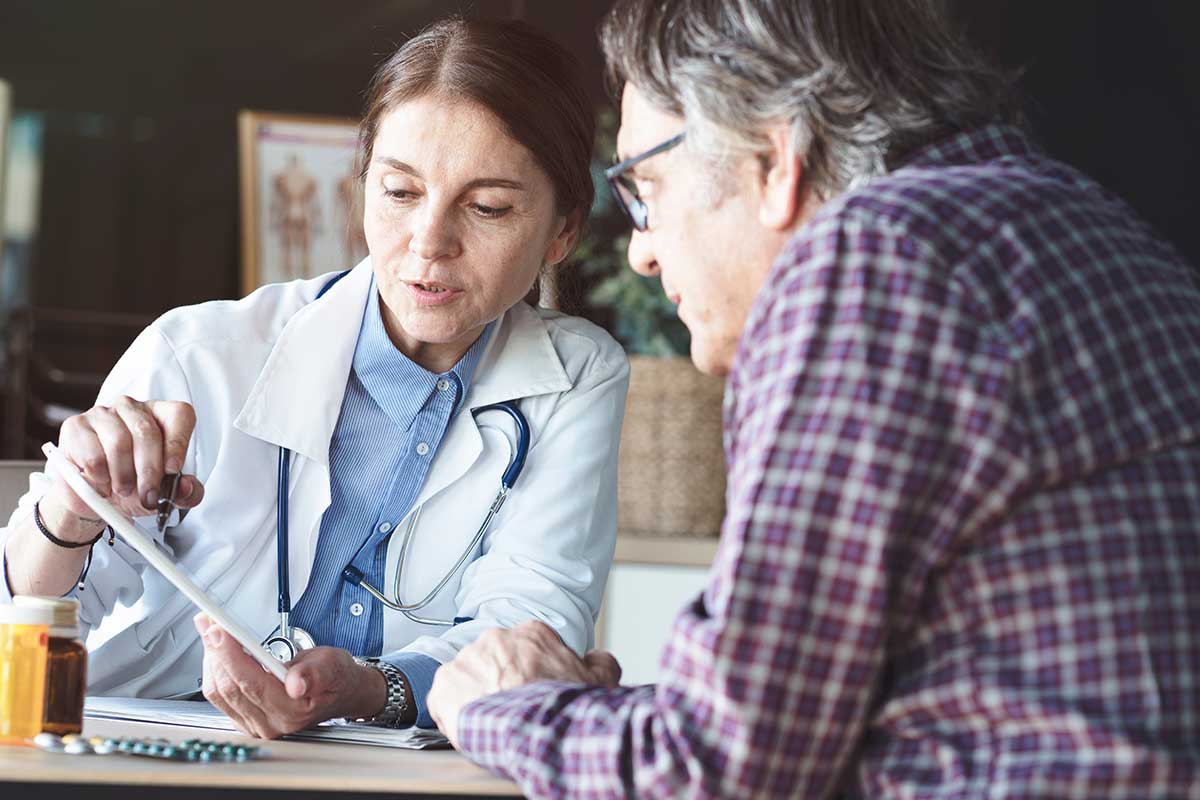 female doctor talking to male patient