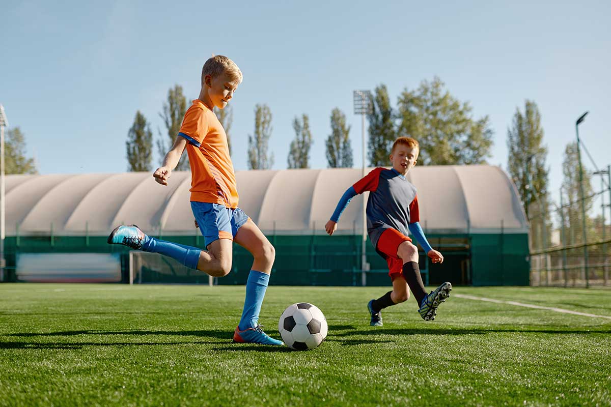 two kids playing soccer