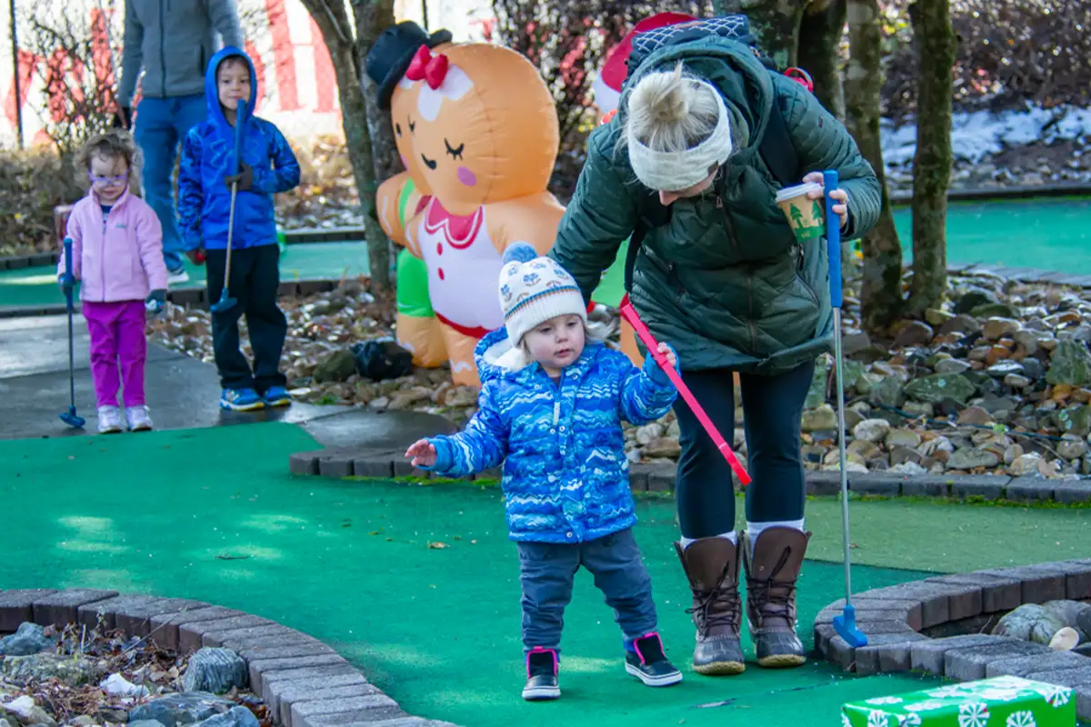 Kids playing mini golf