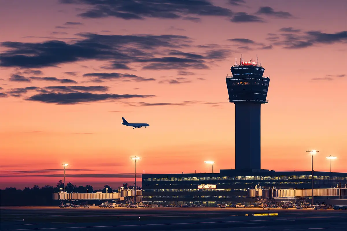A plan flies past the control tower at Dulles International Airport