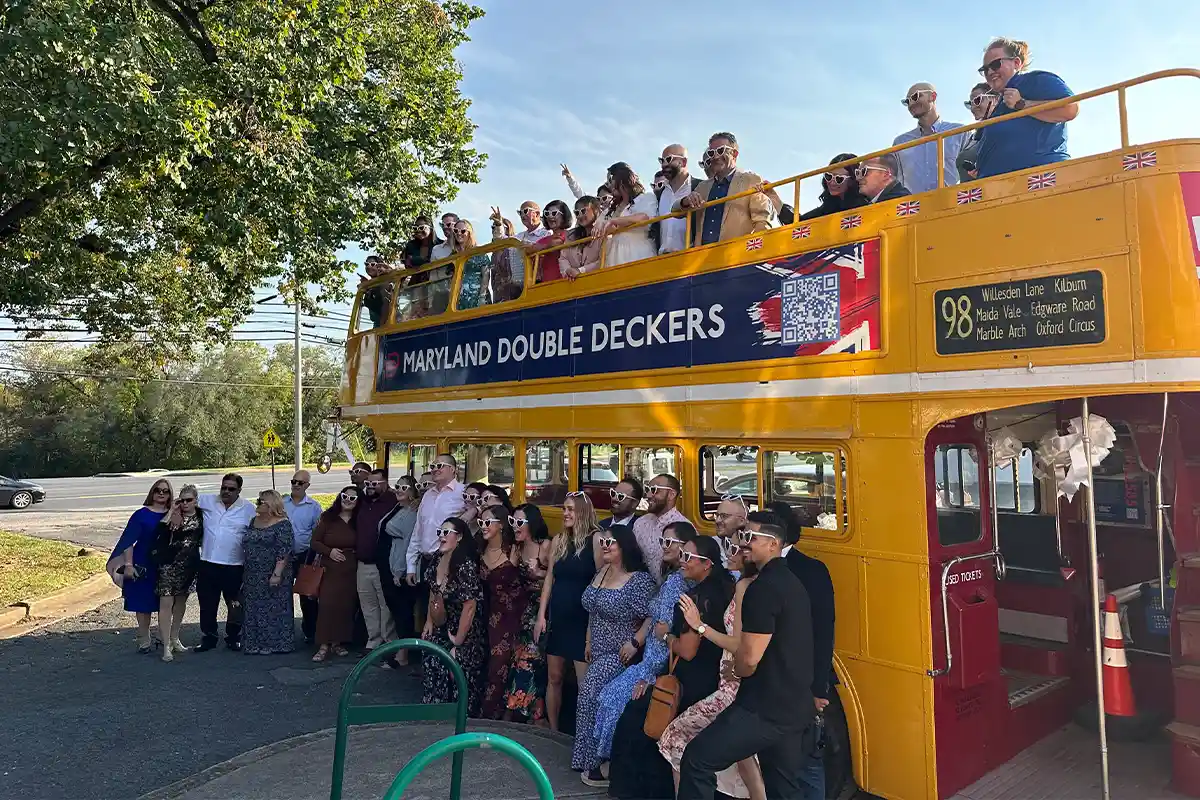 maryland double deckers bus with people on top and bottom