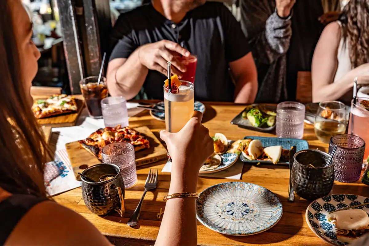 people sit around a table with food and drinks at Palette 22