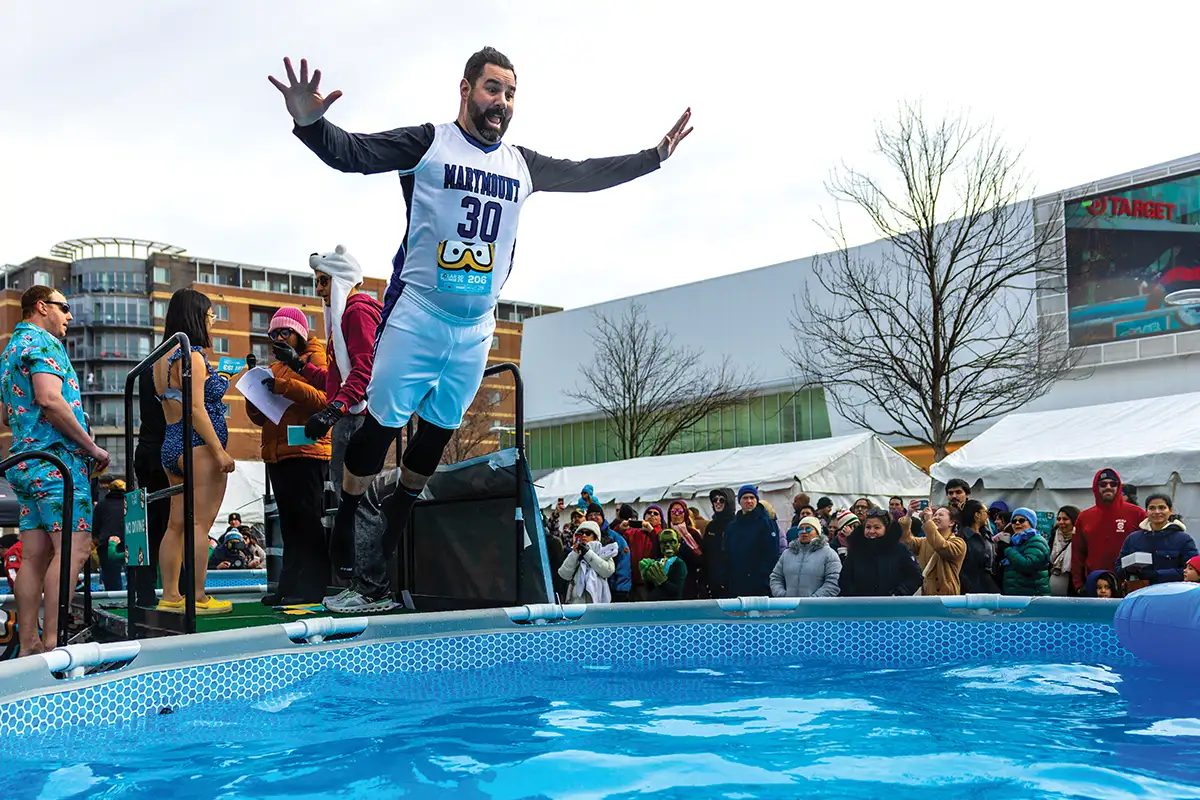 Man jumping into pool for Polar Plunge