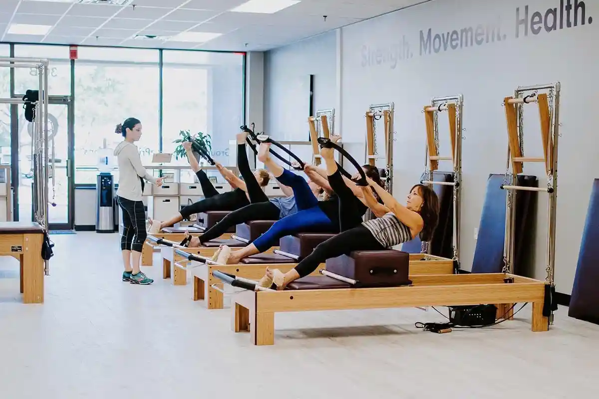 group of women doing reformer pilates
