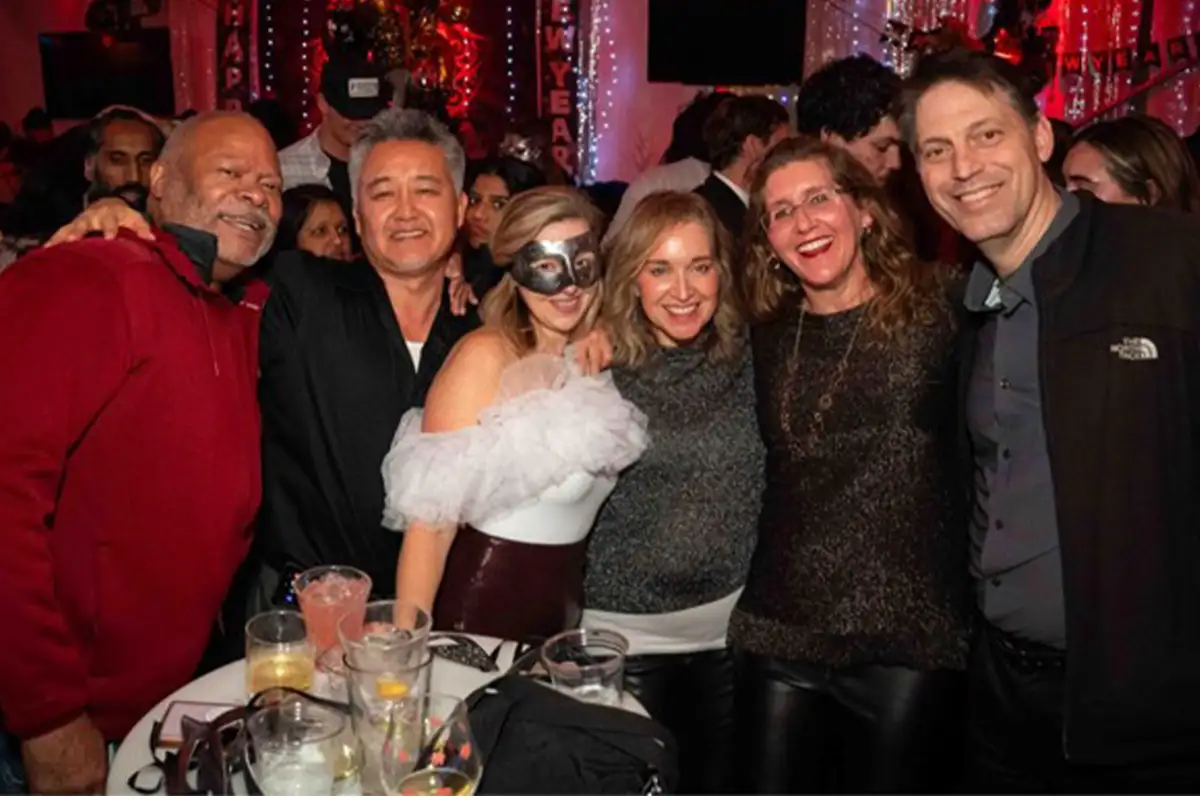 A group of people pose for the camera at Shipgarten's New Year's Eve party